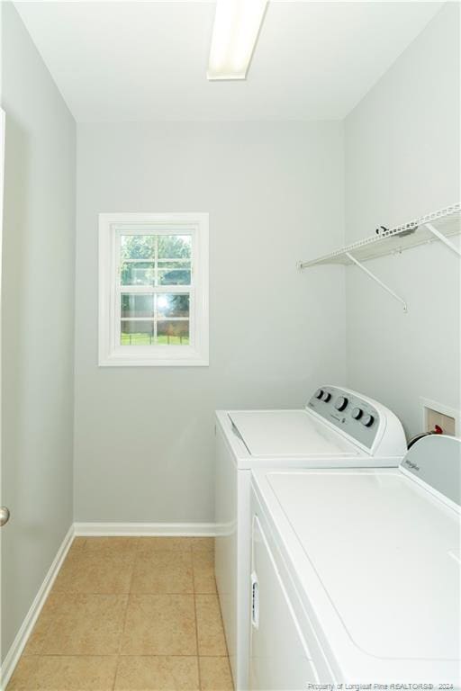 laundry room with light tile patterned flooring and separate washer and dryer