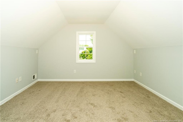 bonus room featuring carpet flooring and vaulted ceiling