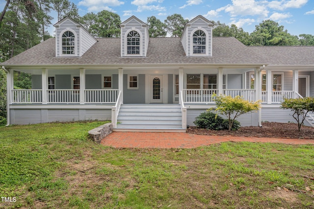 new england style home featuring a front yard and a porch