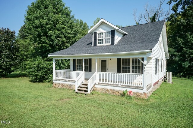 view of front of home with a porch and a front yard