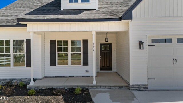 entrance to property with a garage and a porch