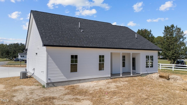 rear view of property featuring cooling unit