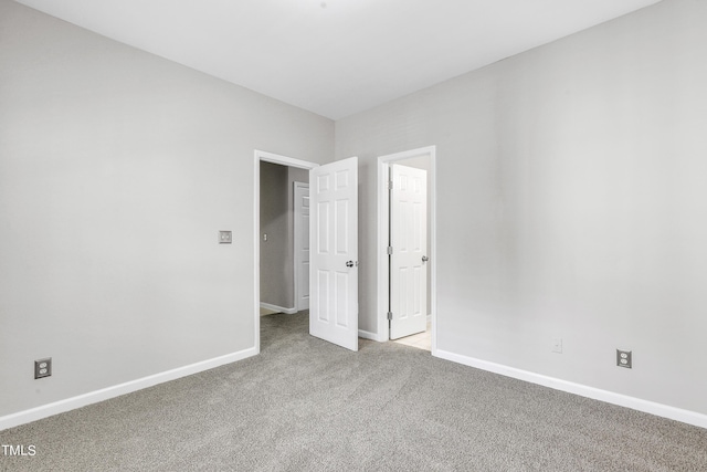 unfurnished bedroom featuring light carpet