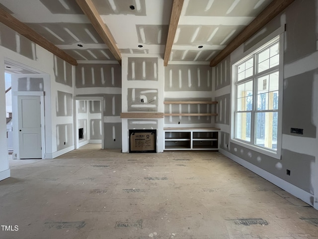 unfurnished living room featuring baseboards