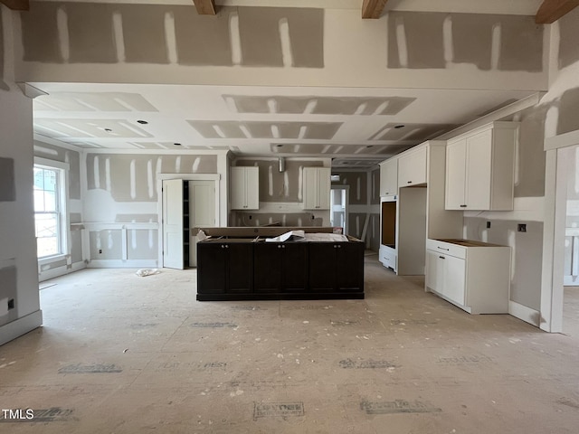 kitchen with a kitchen island and white cabinets