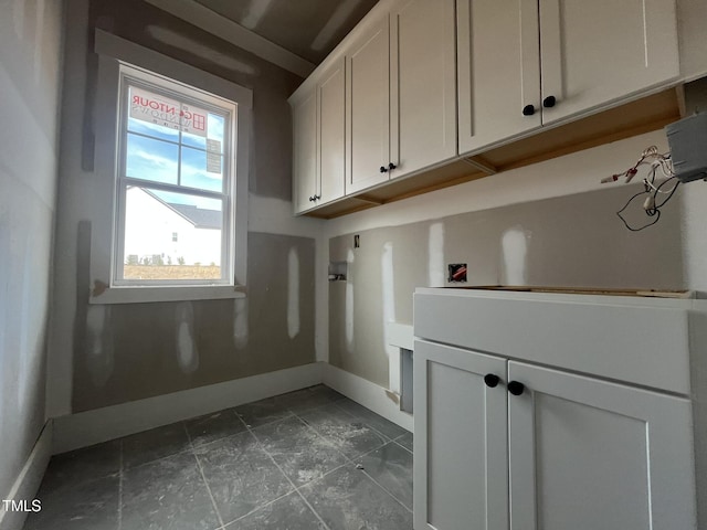 laundry area featuring baseboards