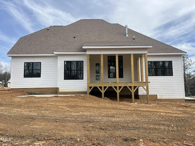 back of house with a shingled roof