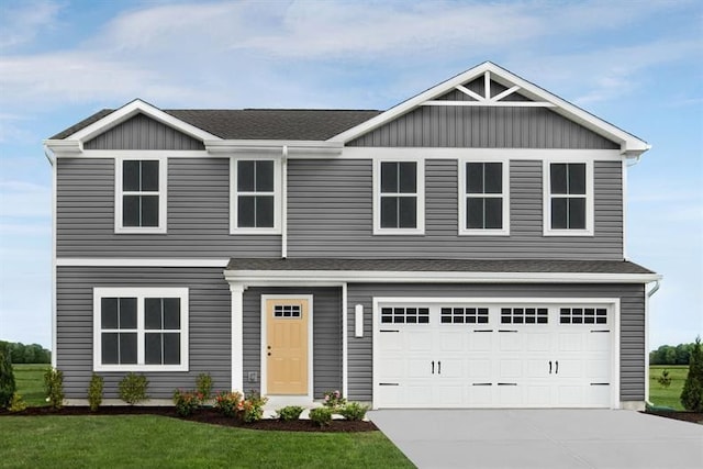 view of front of property featuring a garage and a front lawn