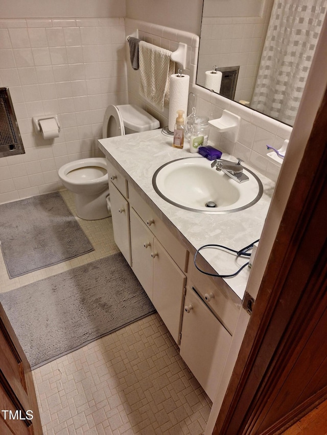 1917 New Hill Olive Chapel Rd, New Hill, NC 27562 - bathroom with tile walls, vanity, and toilet