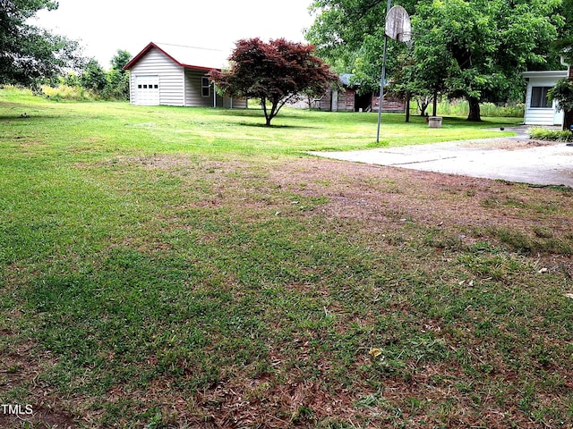 1917 New Hill Olive Chapel Rd, New Hill, NC 27562 - view of grassy yard with a garage