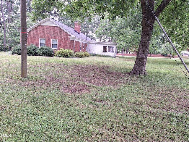 1917 New Hill Olive Chapel Rd, New Hill, NC 27562 - view of front of property with brick siding, a front lawn, and a chimney