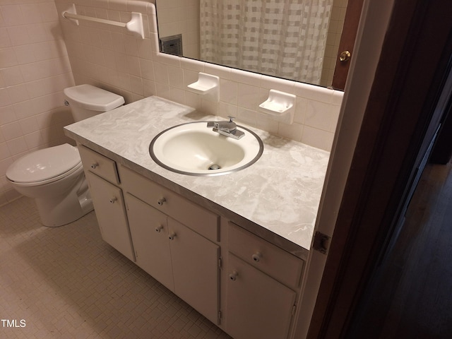 1917 New Hill Olive Chapel Rd, New Hill, NC 27562 - bathroom featuring vanity, toilet, tile walls, and tile patterned flooring