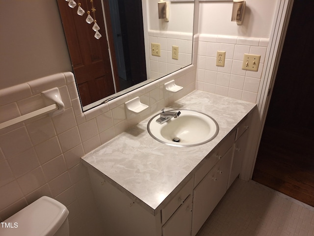 1917 New Hill Olive Chapel Rd, New Hill, NC 27562 - bathroom featuring vanity, tile walls, toilet, and a wainscoted wall