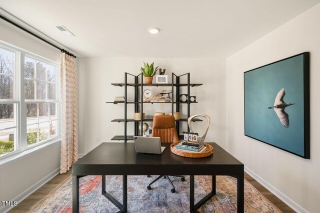 office space with wood-type flooring