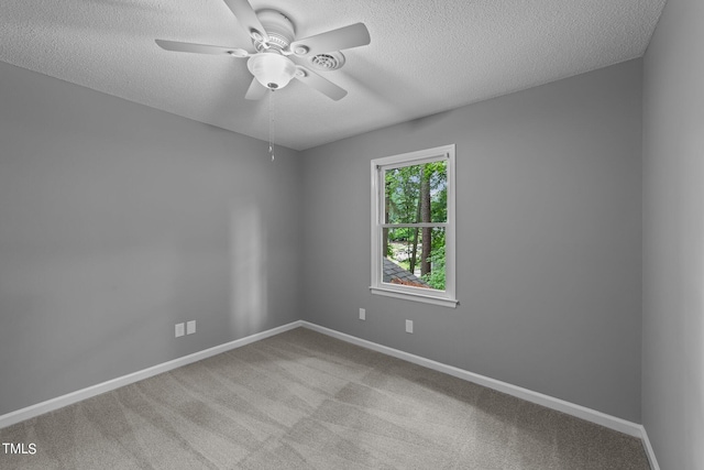 carpeted empty room featuring a textured ceiling and ceiling fan