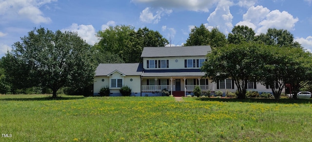 view of front of property with a porch and a front lawn