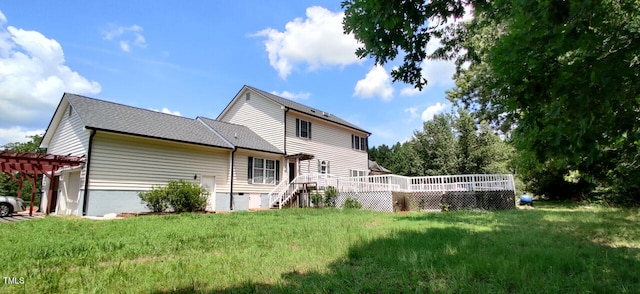 back of property with a wooden deck, a yard, and a pergola