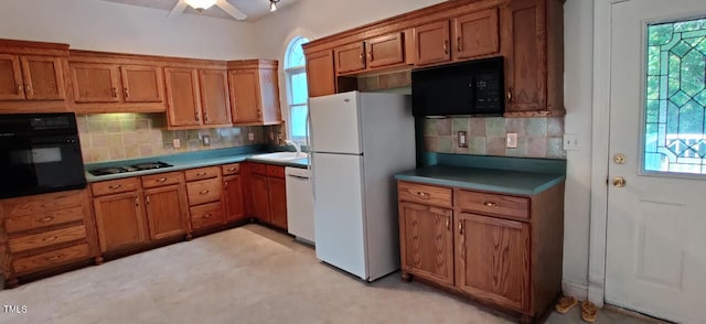 kitchen featuring ceiling fan, sink, decorative backsplash, and black appliances