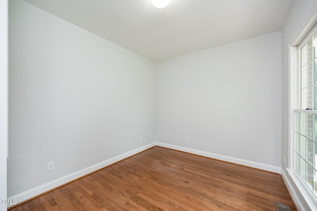 empty room with hardwood / wood-style floors