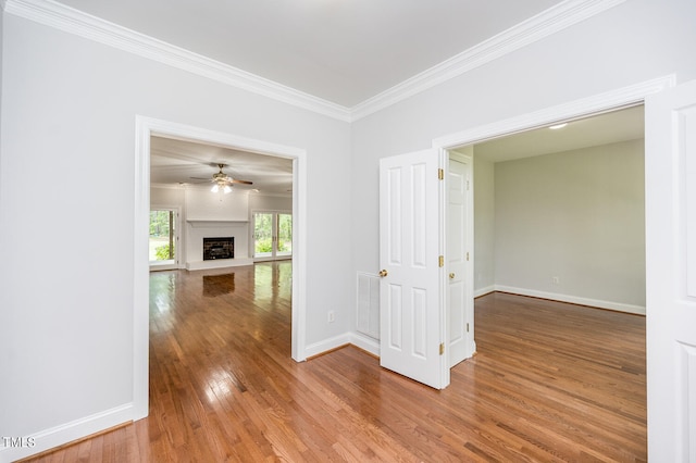 spare room with ceiling fan, hardwood / wood-style flooring, and ornamental molding