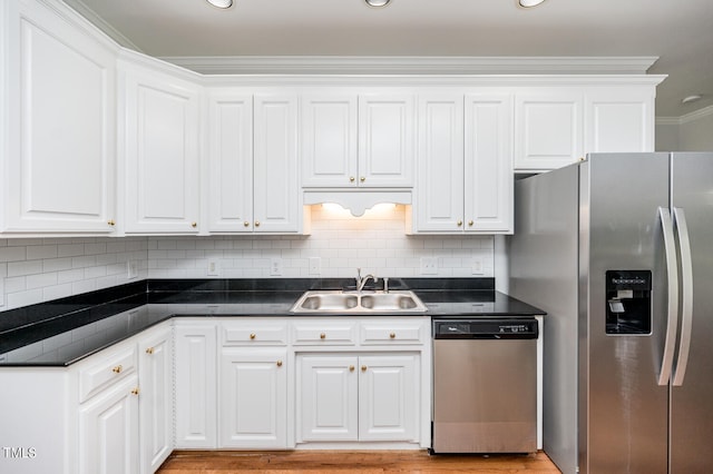 kitchen featuring sink, light hardwood / wood-style flooring, stainless steel appliances, and white cabinetry