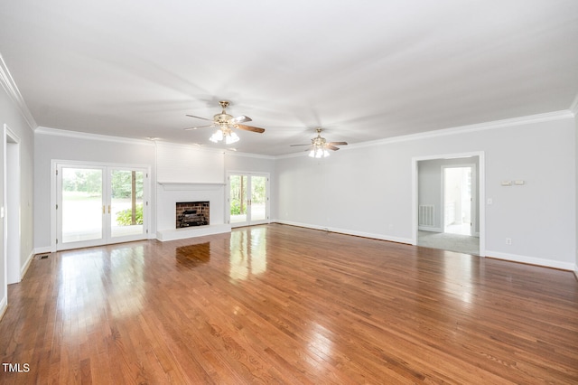 unfurnished living room with a fireplace, light hardwood / wood-style flooring, ornamental molding, and ceiling fan