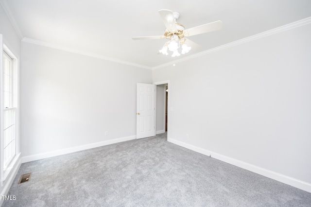 carpeted spare room featuring ceiling fan and ornamental molding