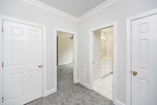 corridor featuring light carpet and ornamental molding