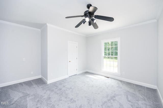 spare room featuring ornamental molding, carpet flooring, and ceiling fan