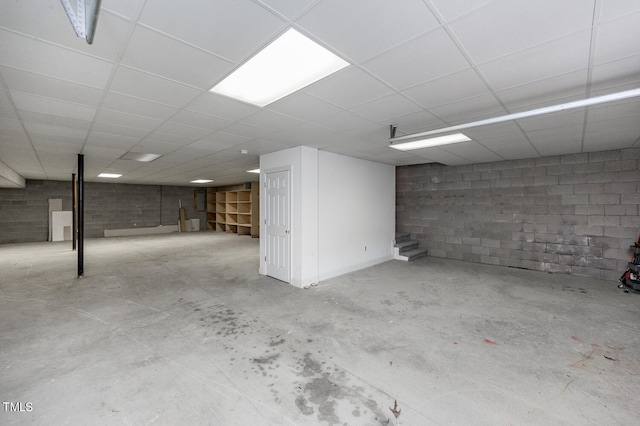 basement featuring a paneled ceiling