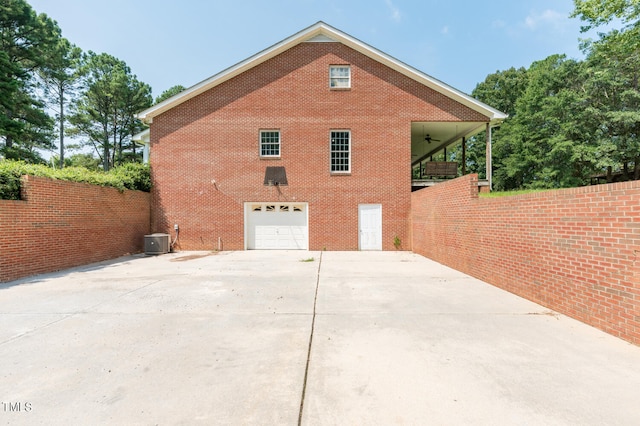 view of side of home featuring a garage and central AC unit