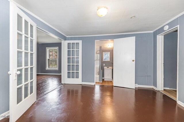 unfurnished room with crown molding, french doors, and wood-type flooring