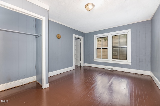 unfurnished bedroom featuring a closet and wood-type flooring