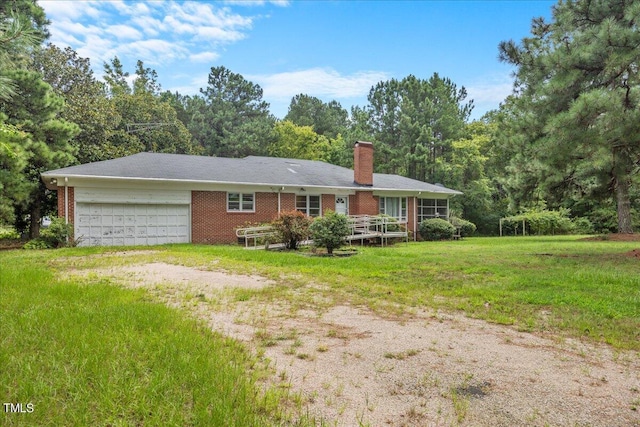 ranch-style home with a garage and a front yard