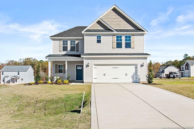 craftsman inspired home featuring a front yard and a garage