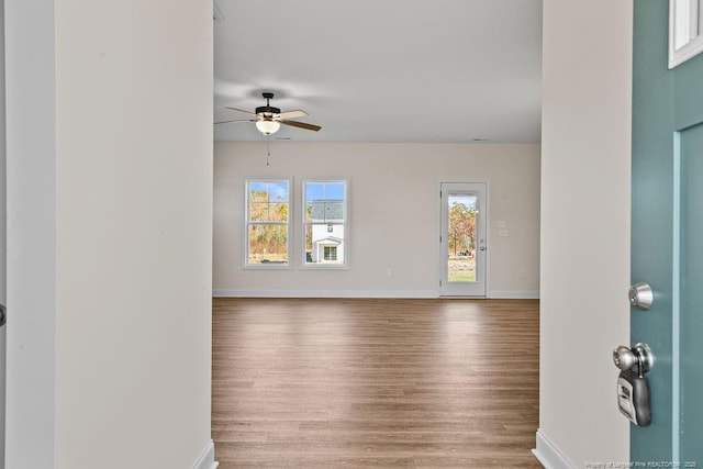 empty room with hardwood / wood-style flooring and ceiling fan