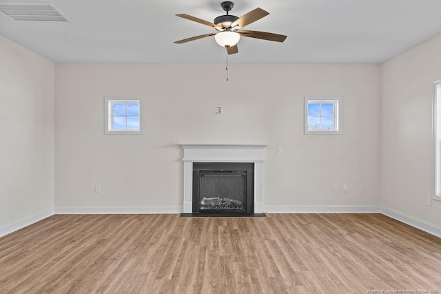 unfurnished living room with ceiling fan and light hardwood / wood-style floors