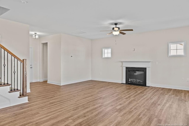 unfurnished living room with ceiling fan and light hardwood / wood-style floors