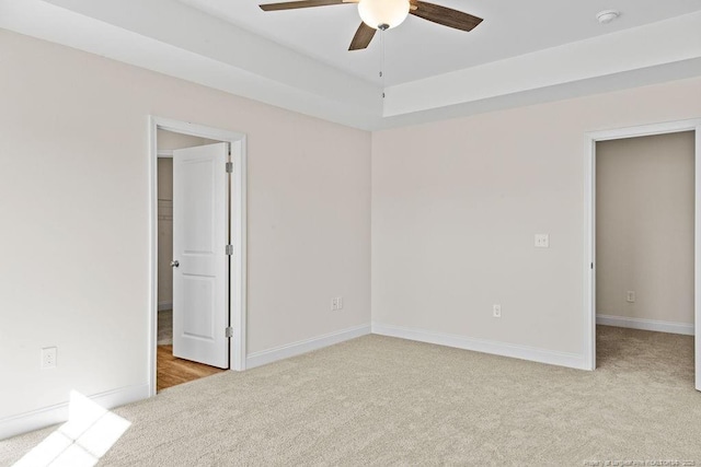 carpeted spare room with ceiling fan