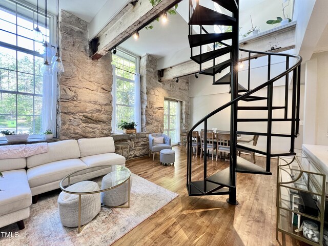 living room with hardwood / wood-style floors and beamed ceiling