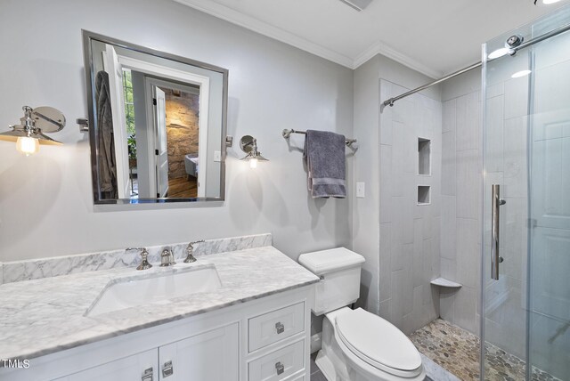 bathroom with walk in shower, toilet, vanity, and ornamental molding