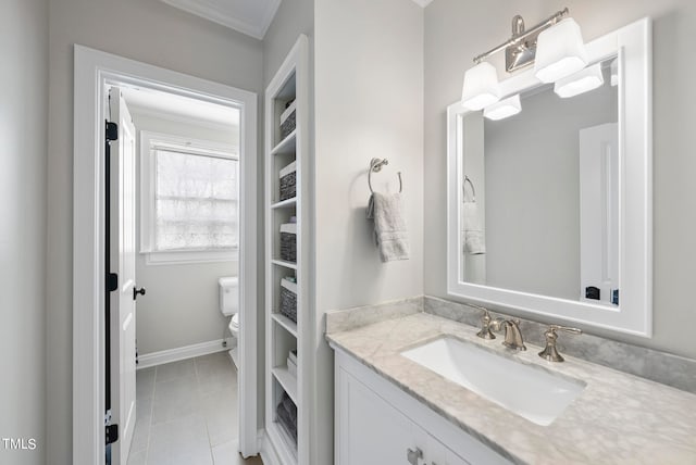 bathroom with tile patterned floors, vanity, toilet, and crown molding