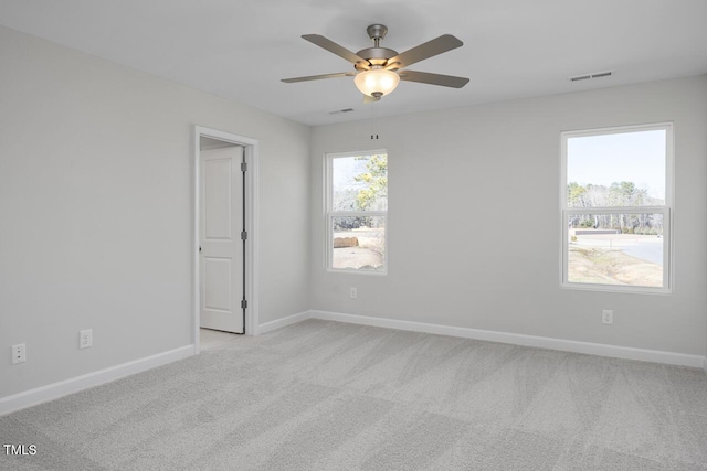 unfurnished room with ceiling fan and light carpet