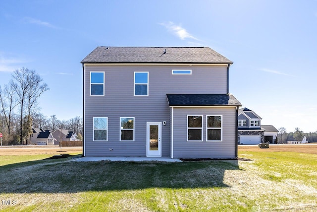 rear view of house featuring a patio area and a yard