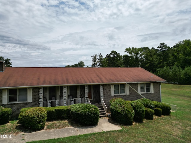 single story home with a front lawn and a porch