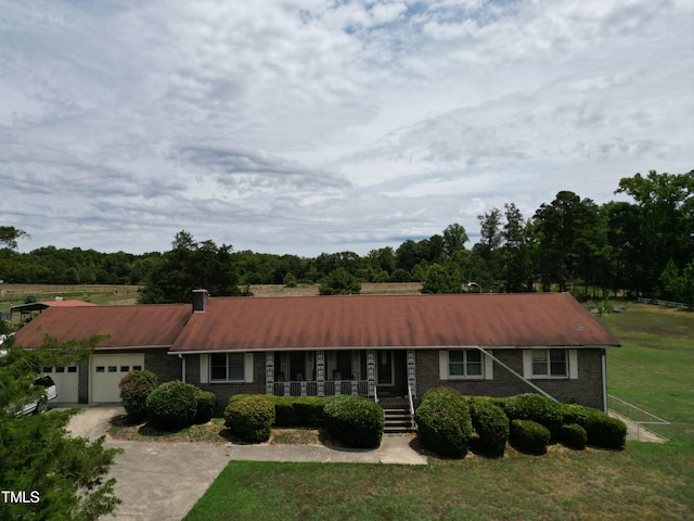 single story home featuring a garage and a front yard