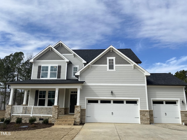 craftsman inspired home with a garage and covered porch