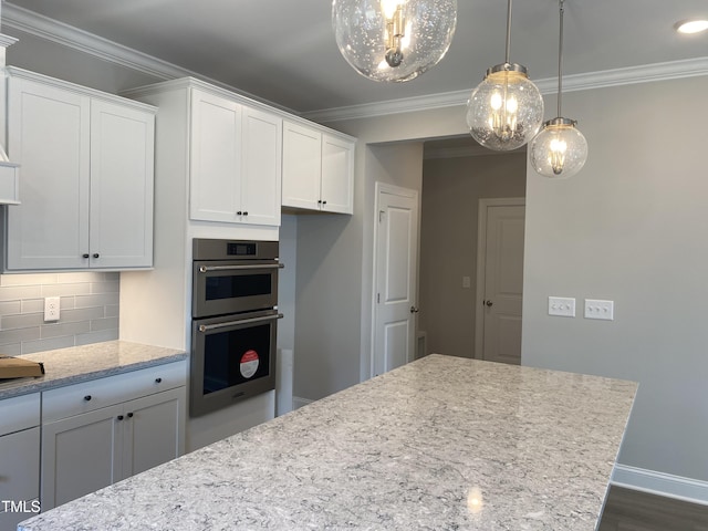 kitchen featuring tasteful backsplash, crown molding, stainless steel double oven, and white cabinets