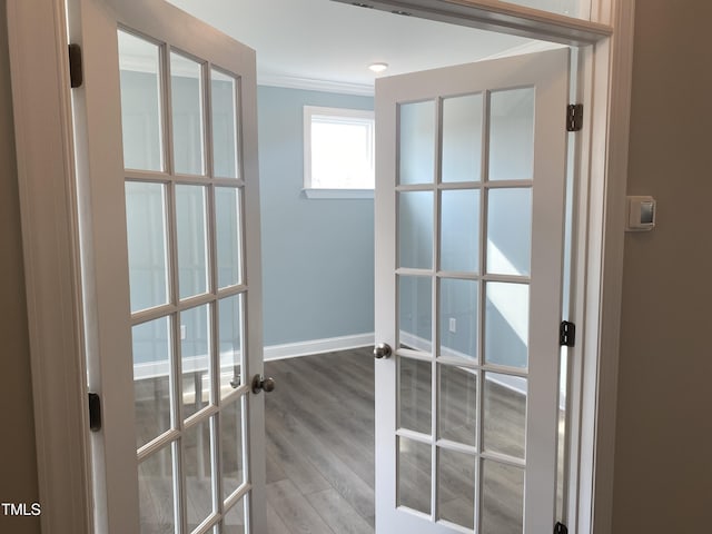 entryway with ornamental molding, french doors, baseboards, and wood finished floors