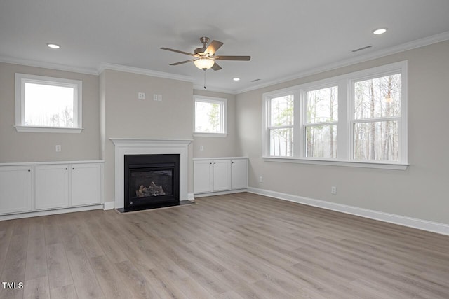 unfurnished living room featuring baseboards, visible vents, a fireplace with flush hearth, ornamental molding, and light wood-type flooring